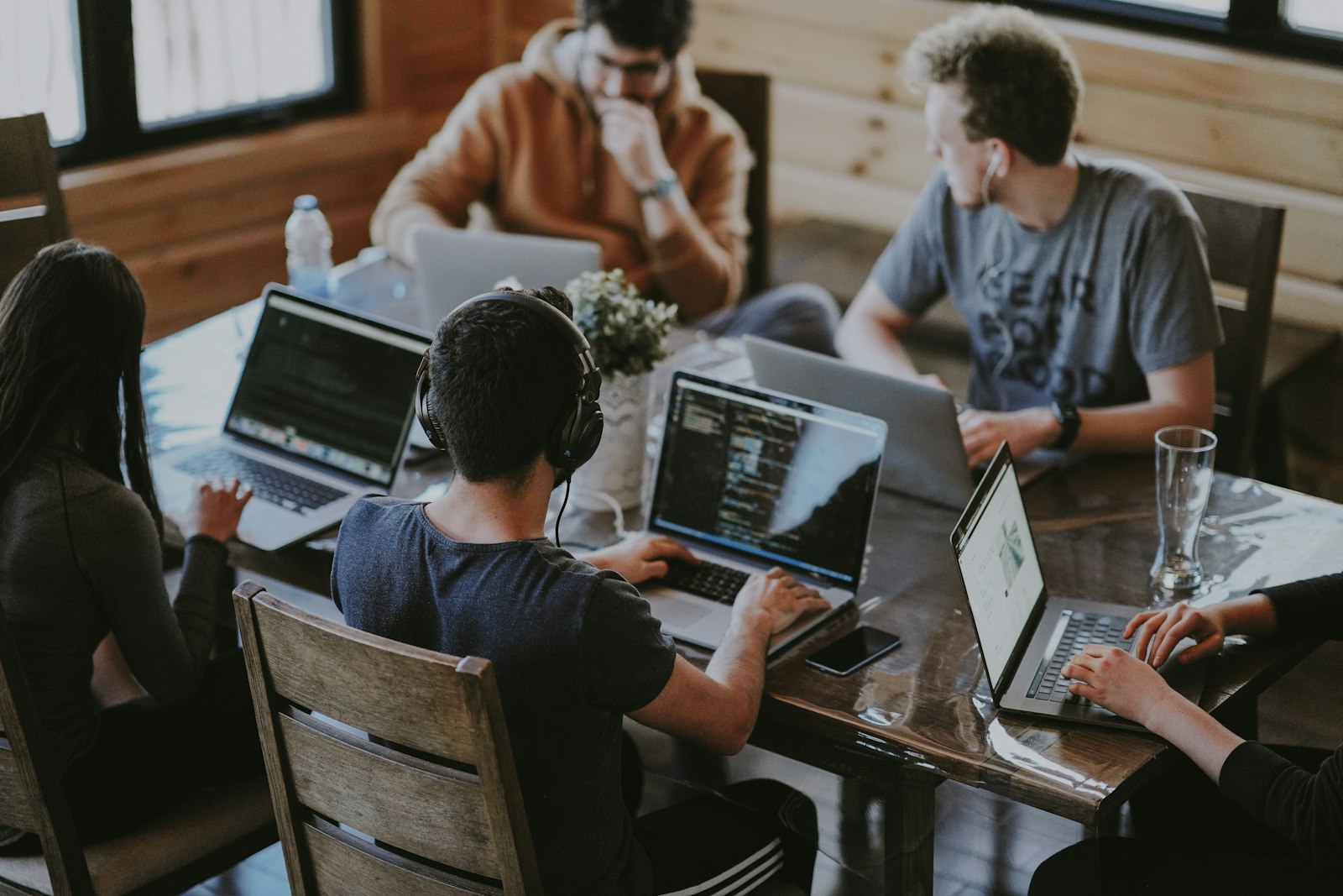 Digital marketing team collaborating around code in a modern office
